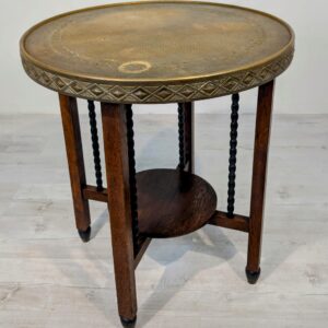 Wooden table with brass embossed top
