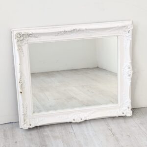Baroque-style wall mirror in a whitewashed frame